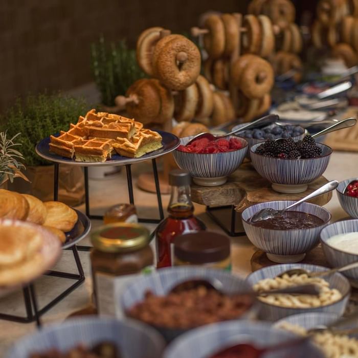 Breakfast buffet with waffles, berries, bagels, and assorted spreads at Falkensteiner Hotel & Spa Jesolo