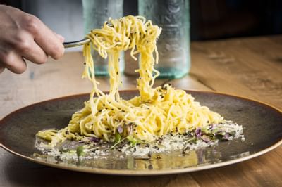 a man curling pasta on a fork