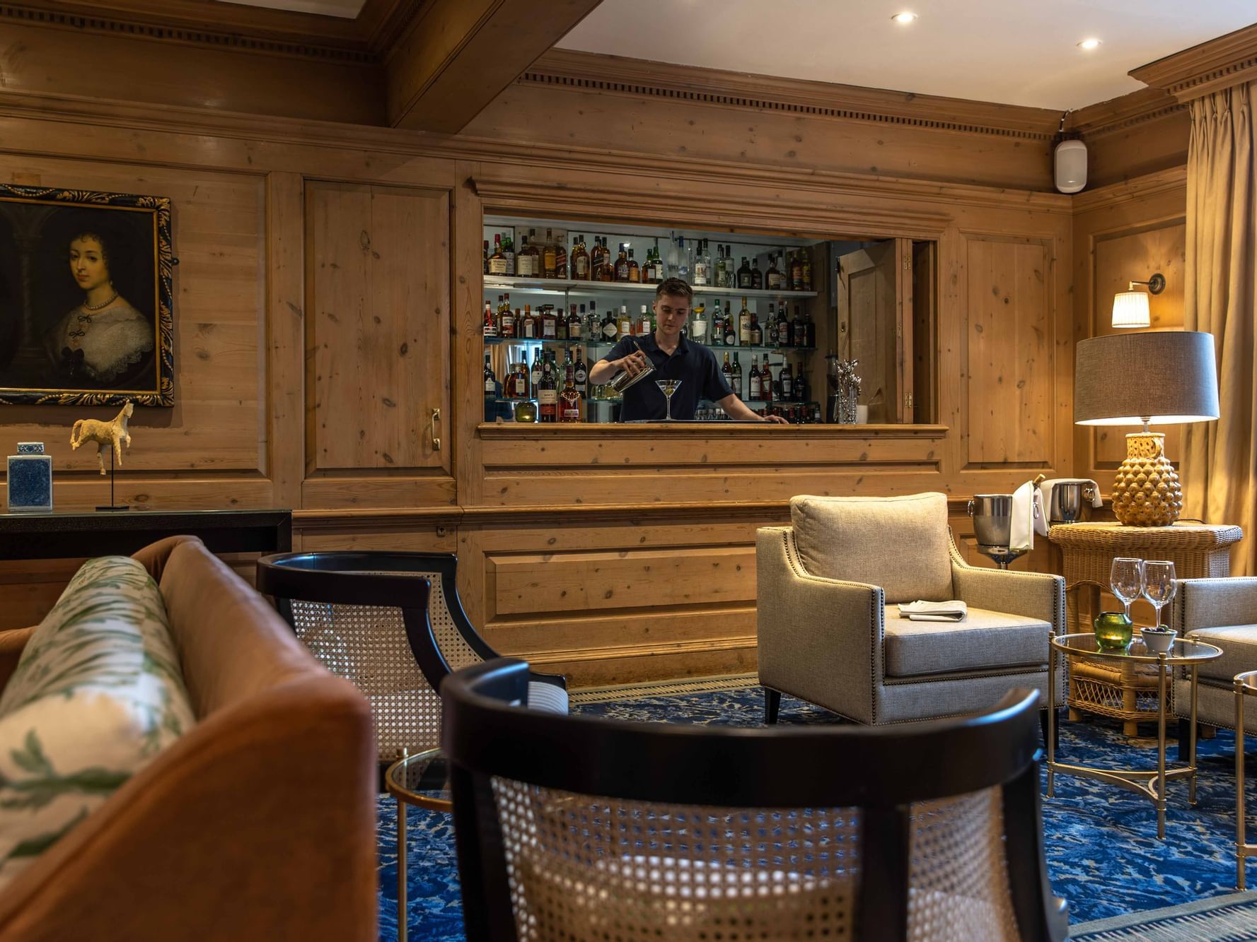 A bartender making drinks in The Clip Bar at The Relais Henley