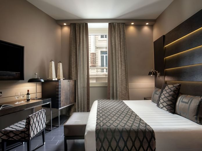 Interior of the Superior Room with a work desk by the king bed and window at The Style