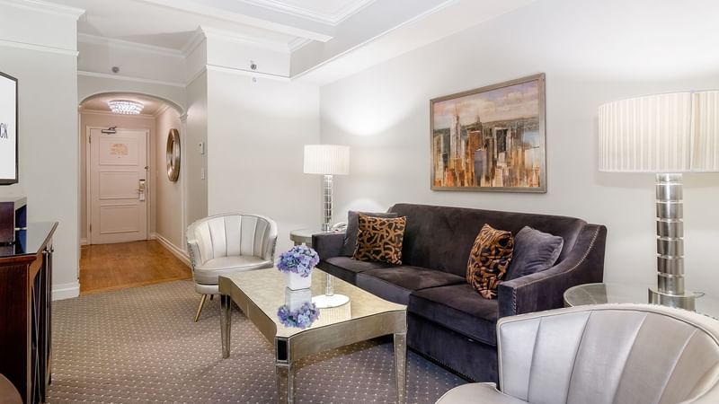 Living area with working table and couch in Premier Suite at Warwick New York