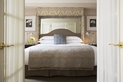 Front view of a king bed in a bedroom at The Eliot Hotel