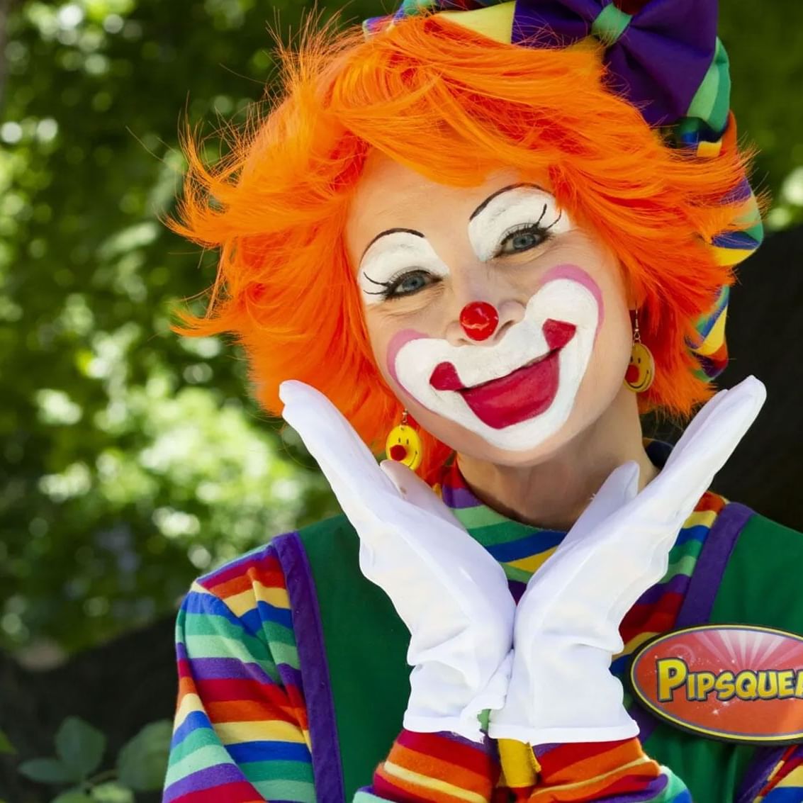 A cheerful clown featuring striking orange hair and a prominent red nose at High Peaks Resort