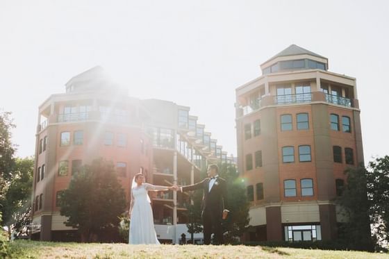 Wedded couple holding hands outdoors at Amora Hotel Melbourne