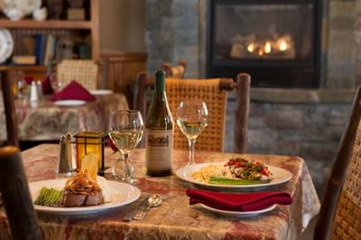 Dinner table with entrees and wine bottle
