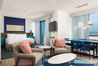 two chairs and a table in a hotel room