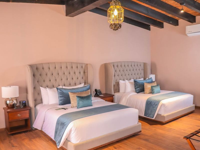 Two queen beds with cushions in Junior Suite at Gamma Hotels