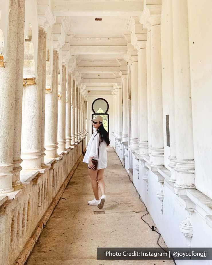 A woman was taking a picture in the corridor of Kellie's Castle - Lexis Suites Penang