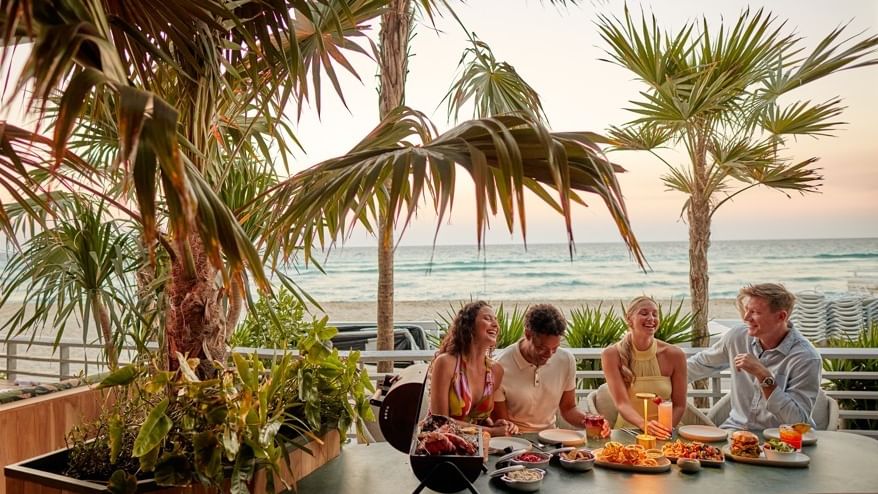 Enjoying oceanfront dining at our beachfront restaurant on the sand.