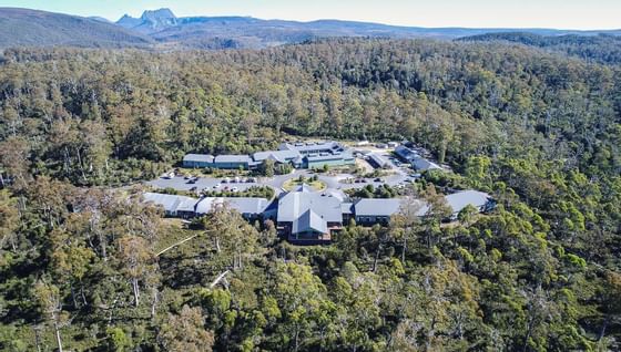 Aerial view of the Cradle Mountain Hotel surrounded by trees