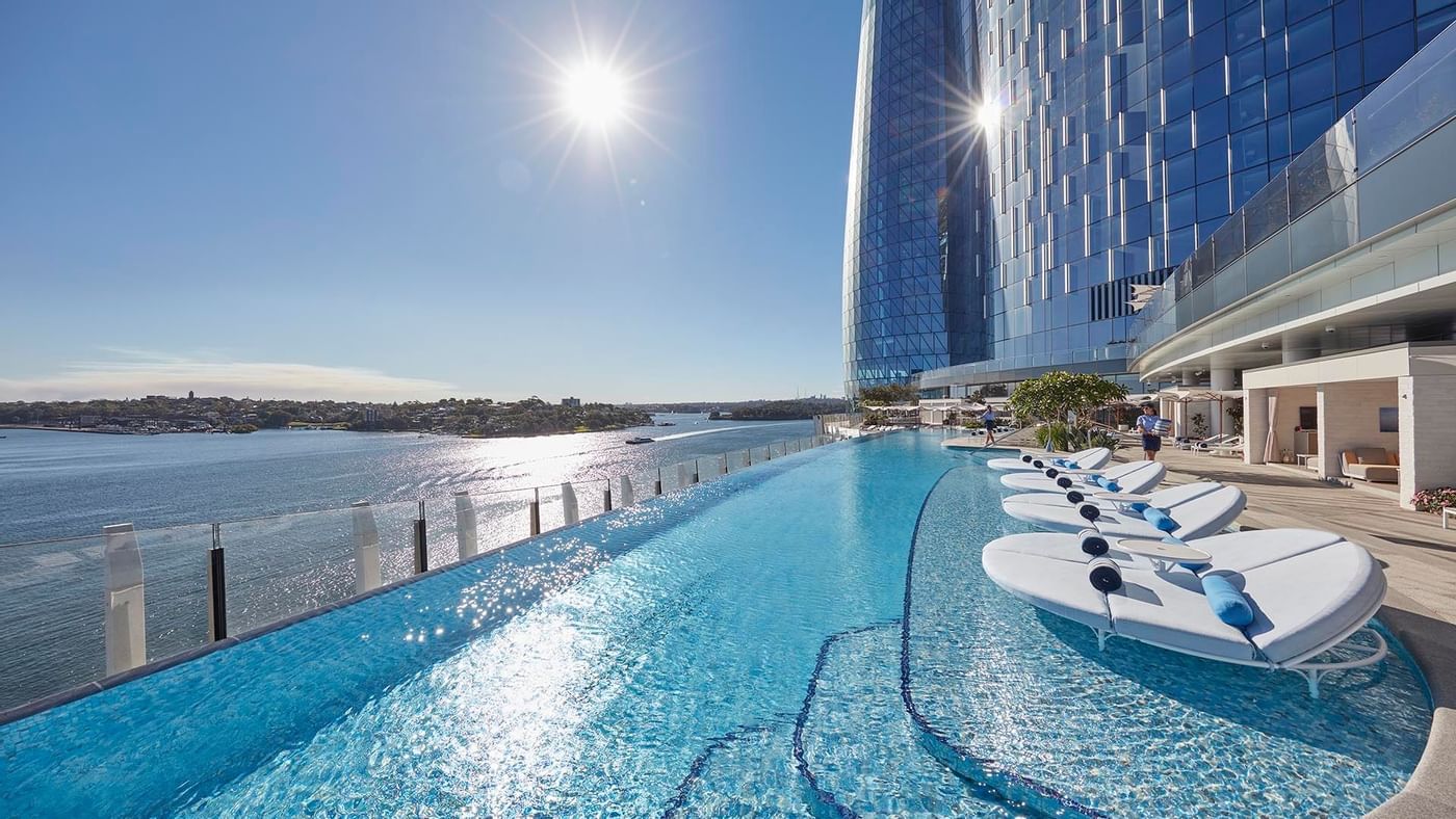 Pool area with sun loungers at Crown Hotels