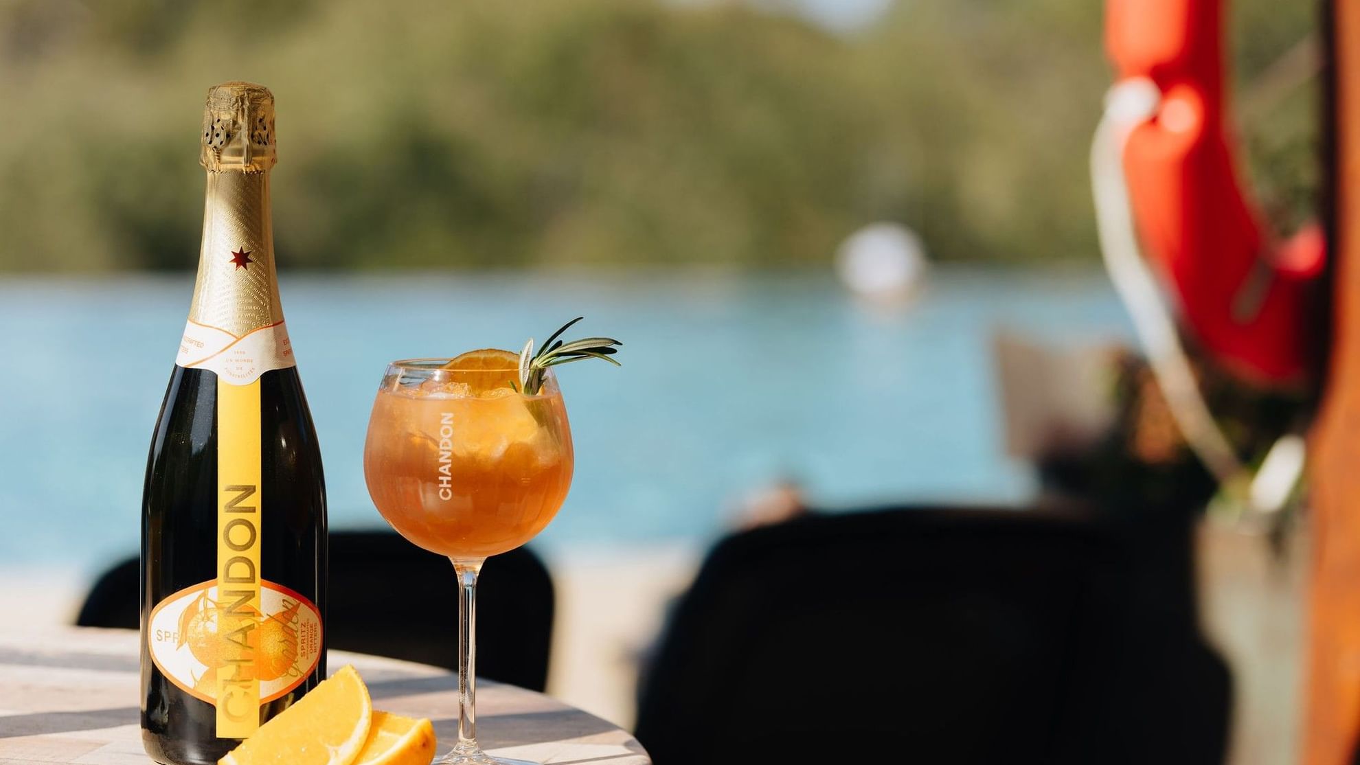 Chandon bottle and orange cocktail by the pool at Pullman Bunker Bay Resort
