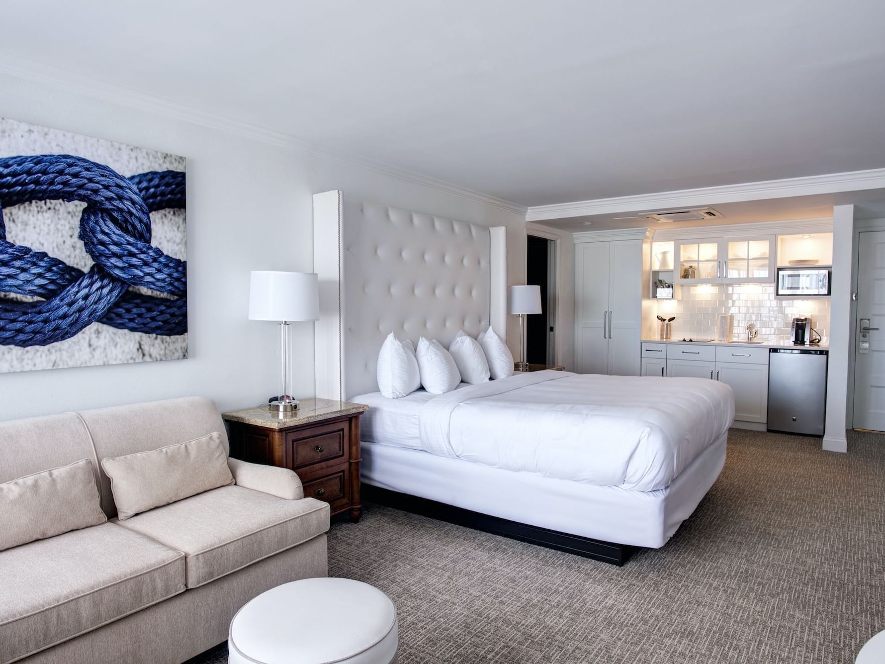 White bed with furniture in Classic King Studio at ICONA Avalon