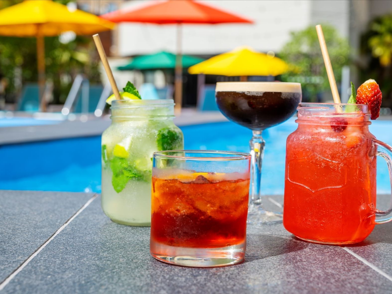 Close-up of four cocktails near the pool at Hotel Grand Chancellor Adelaide