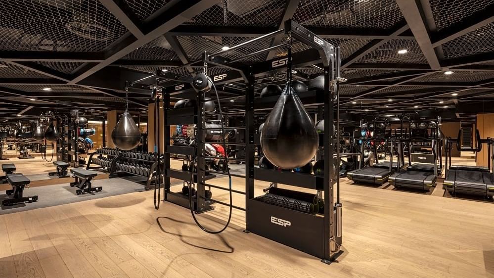 Fitness center with well-equipped machines & weights at The Londoner Hotel