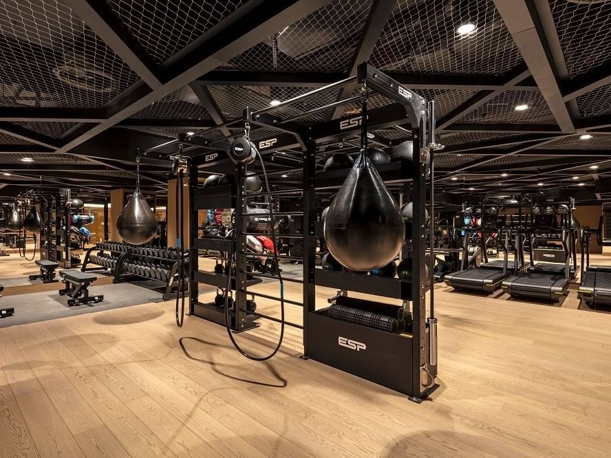 Gym with heavy lifting machinery at The Londoner Hotel