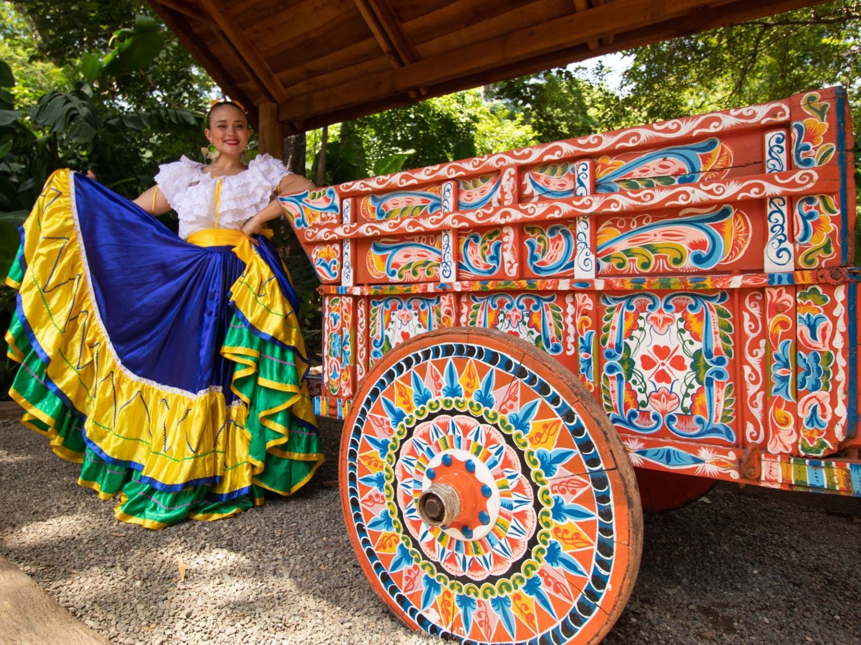 A lady in a fancy skirt by a cart in Guanacaste near Villas Sol Beach Resort