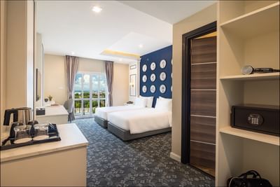 TV stand facing the king bed with pictures in Superior Balcony City View at Eastin Vientiane Laos