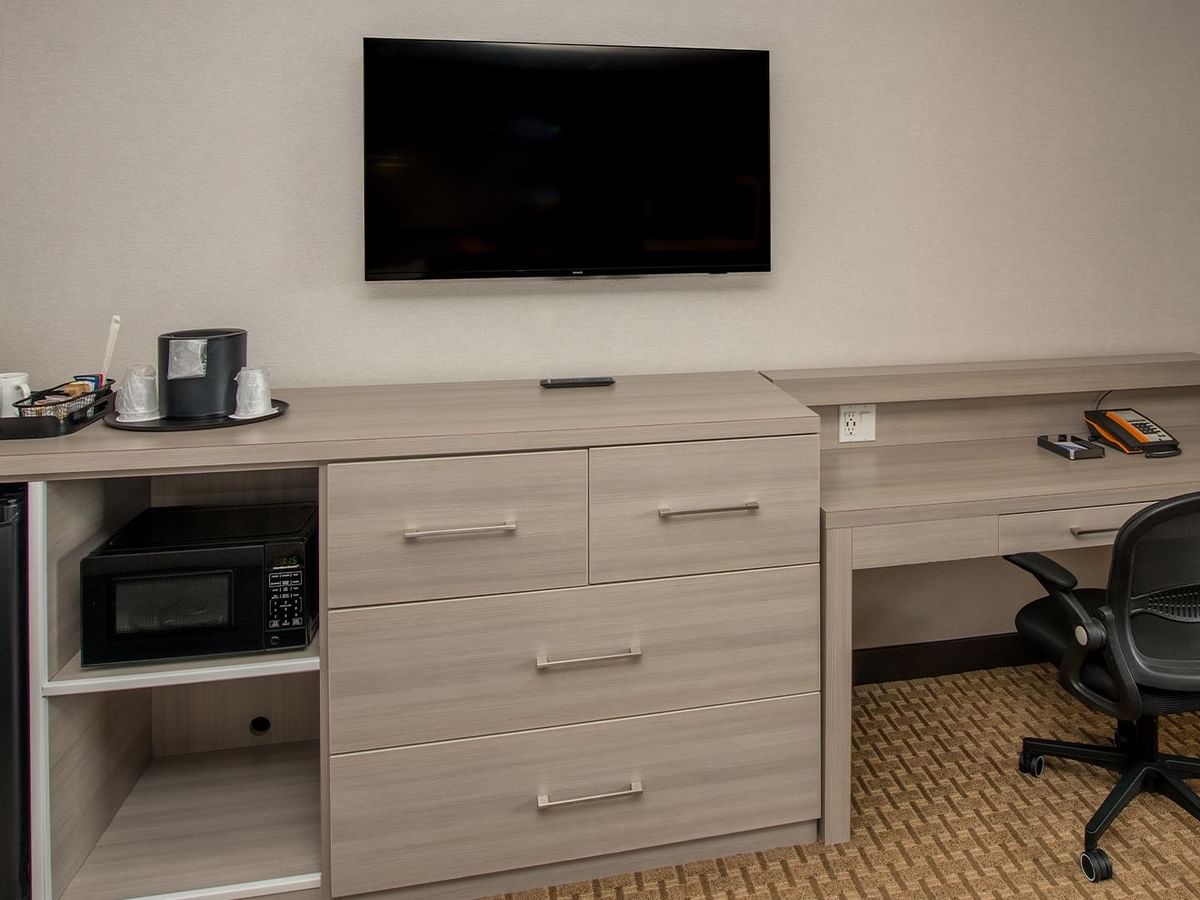 Coast Premium King room with work desk, coffee maker, mini-fridge, and wall-mounted TV at Coast Calgary University Area Hotel by APA