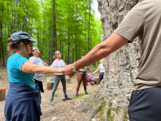 People holding hands in Healing Chakra Retreat near Honor's Haven Retreat