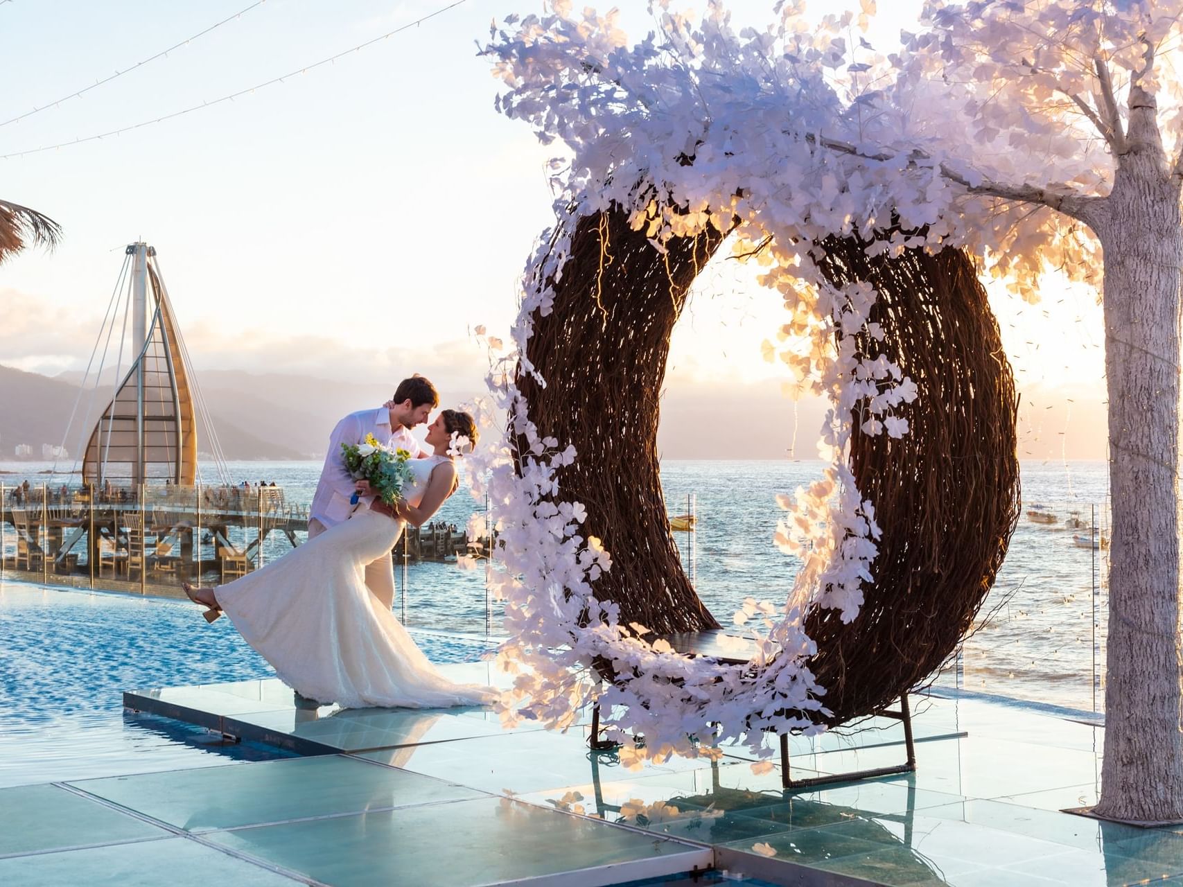 Newly wedded couple posing with a Sea view at Los Arcos Suites