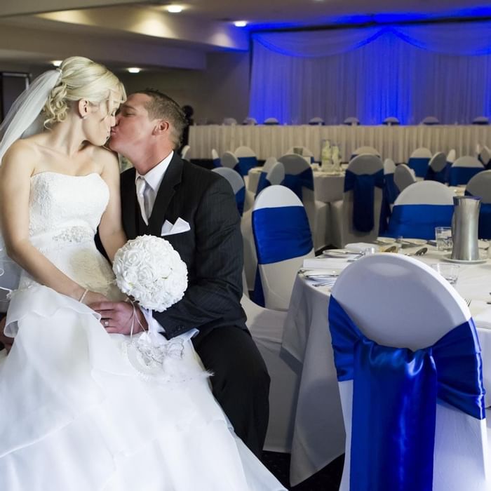 Bride and groom share a romantic moment at decorated wedding reception in Mercure Townsville