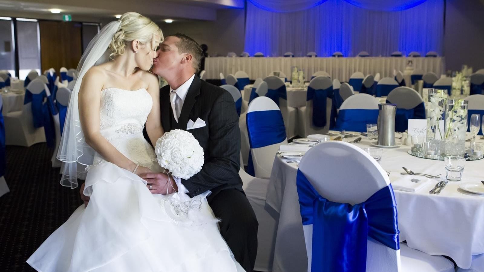 Bride and groom share a romantic moment at decorated wedding reception in Mercure Townsville