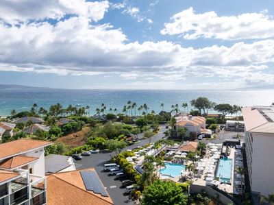 Aerial view of sand bunkers by a pond under a mountain range at Maui Coast Hotel