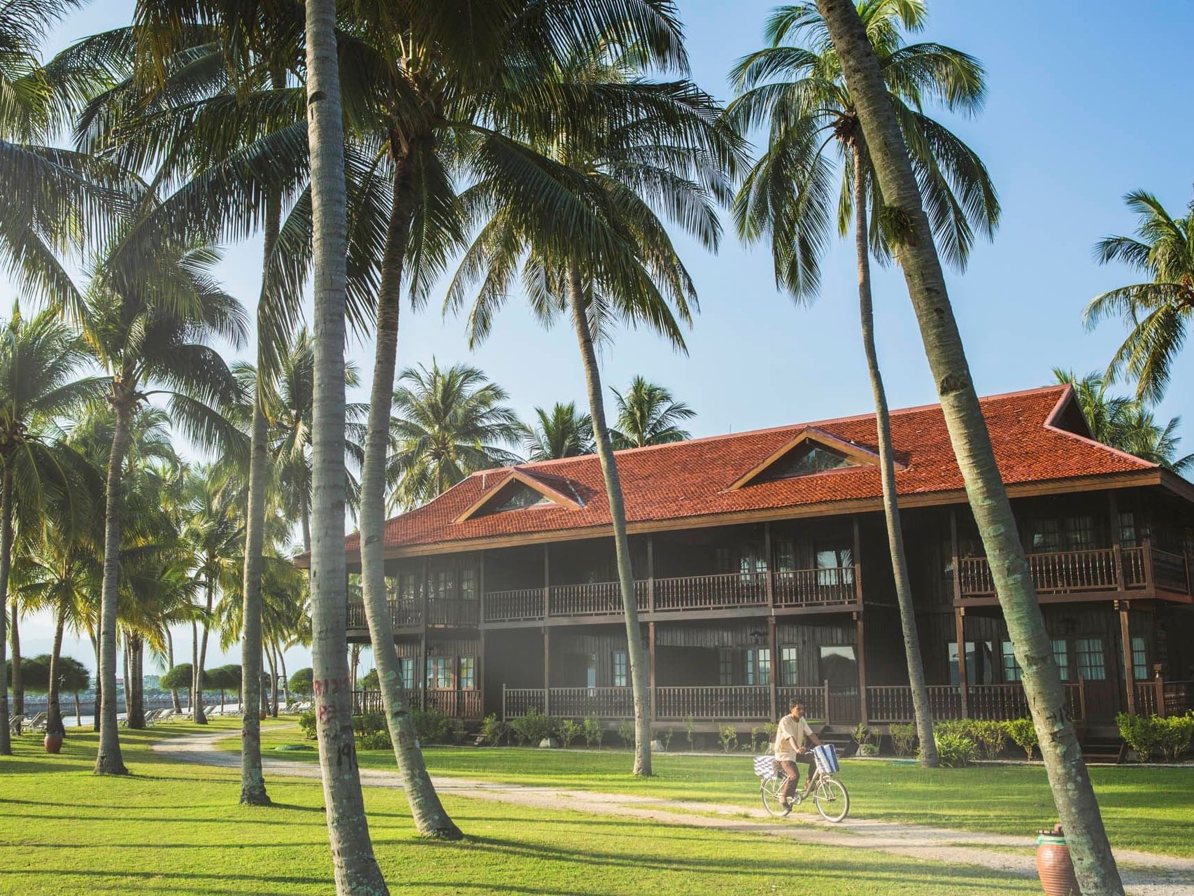 Man riding a bicycle outdoors at Pelangi Beach Resort & Spa