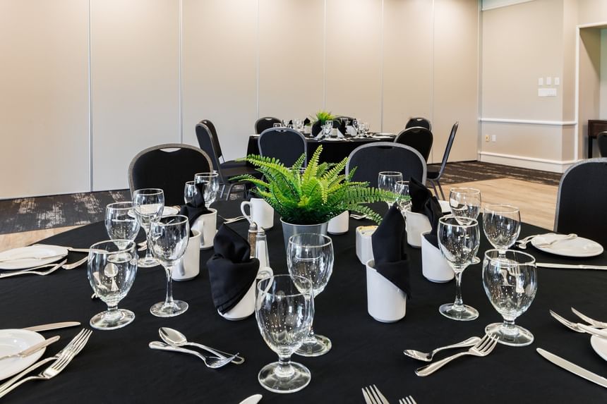 Georgetown with a Table setting featuring a green plant in a pot surrounded by wine glasses at Rodd Brudenell River Resort