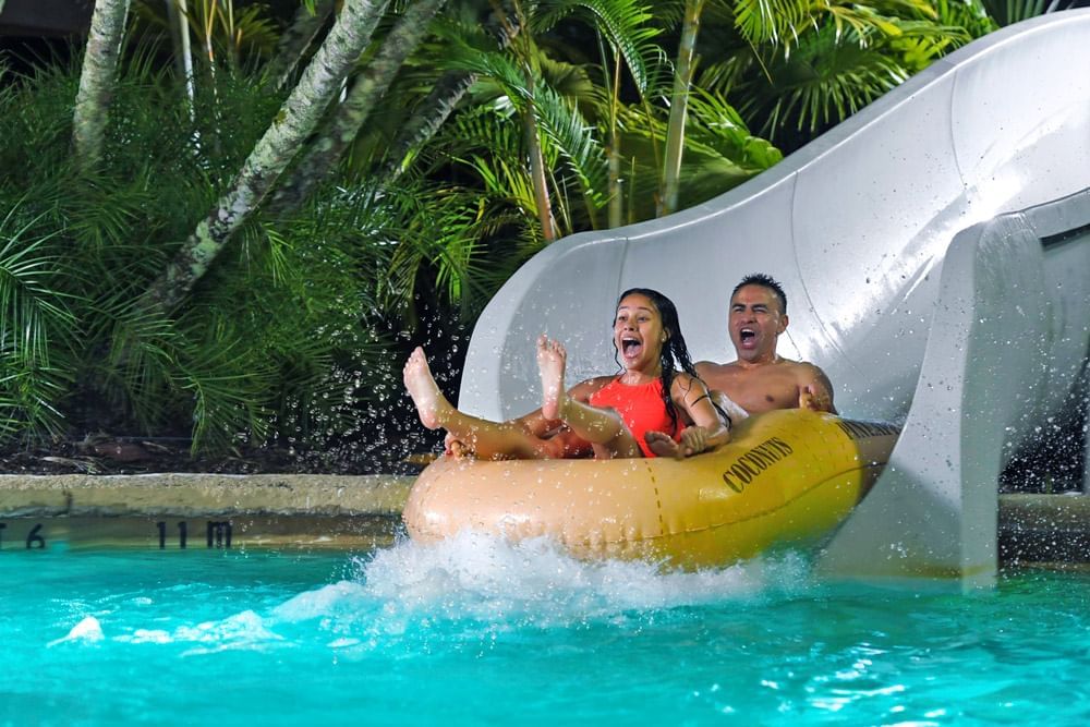 Couple enjoying waterslide at Disney's Typhoon Lagoon near Lake Buena Vista Resort Village & Spa