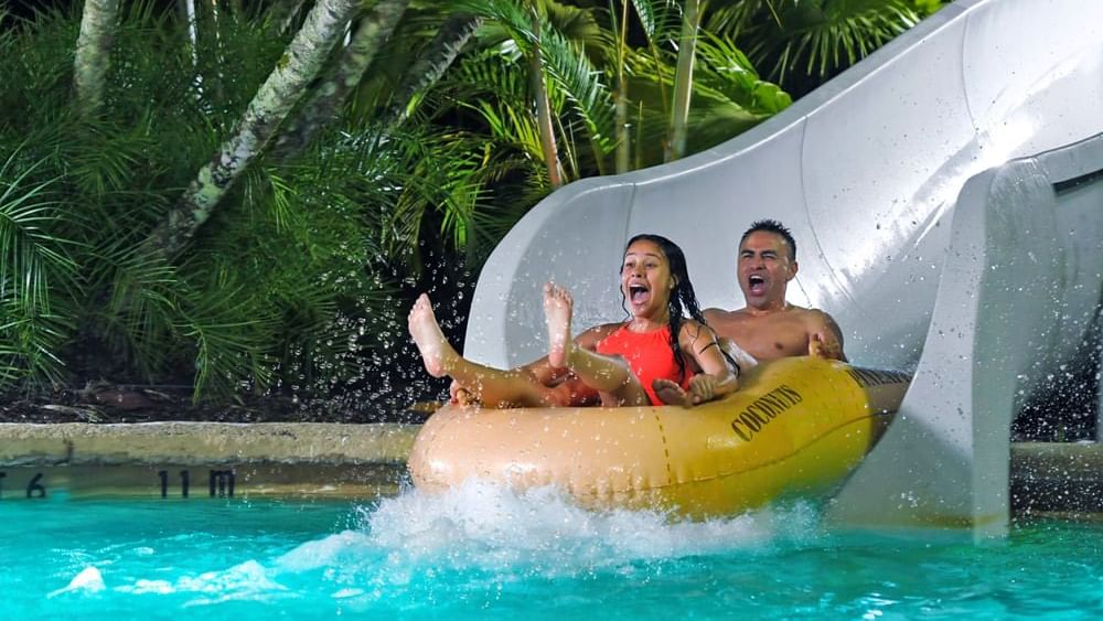 Couple enjoying waterslide at Disney's Typhoon Lagoon near Lake Buena Vista Resort Village & Spa