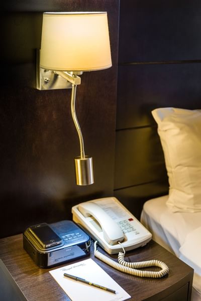bed table with lamp and phone