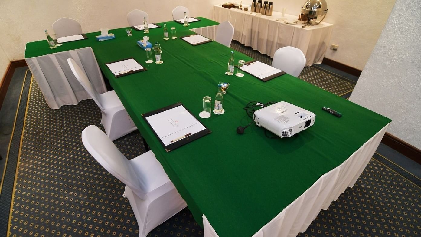 Meeting room with projector and green table at Serena Beach Resort & Spa in Mombasa.