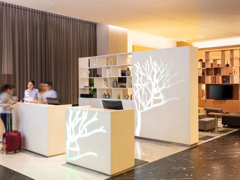 People at the front desk in Fiesta Inn Cancun Las Americas