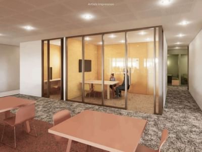 Modern open office space with glass walls, furniture, and two people at UniLodge Brisbane City.