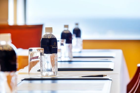 Water bottles are placed on a meeting table at Grand Park Otaru