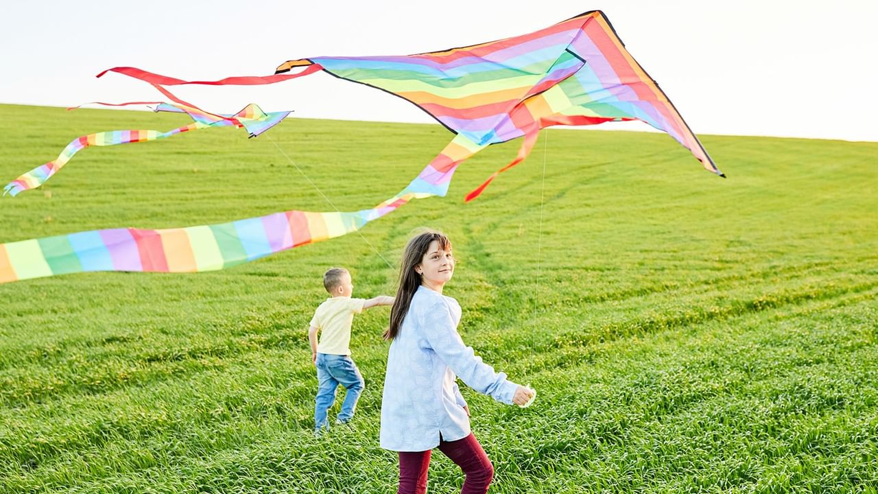 Two kids flying a kite