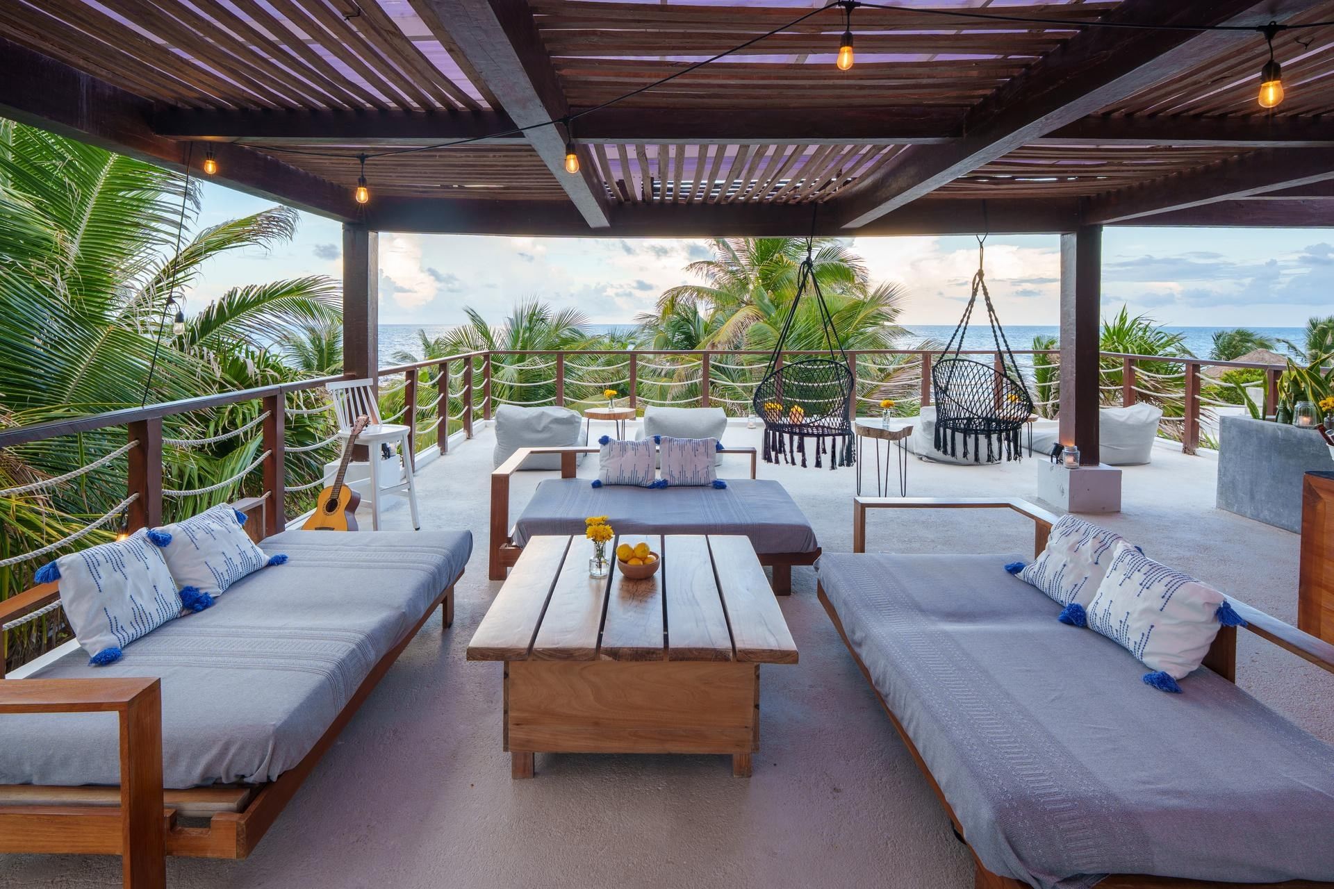 Rooftop lounge at La Zebra Hotel with comfortable seating and a stunning ocean view.