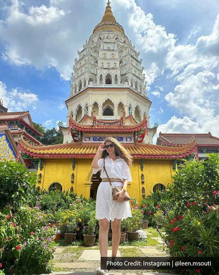 A woman was taking a picture inside the Kek Lok Si temple - Lexis Suites Penang