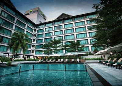 Outdoor swimming pool area with hotel exterior view at MiCasa All Suite Hotel KL