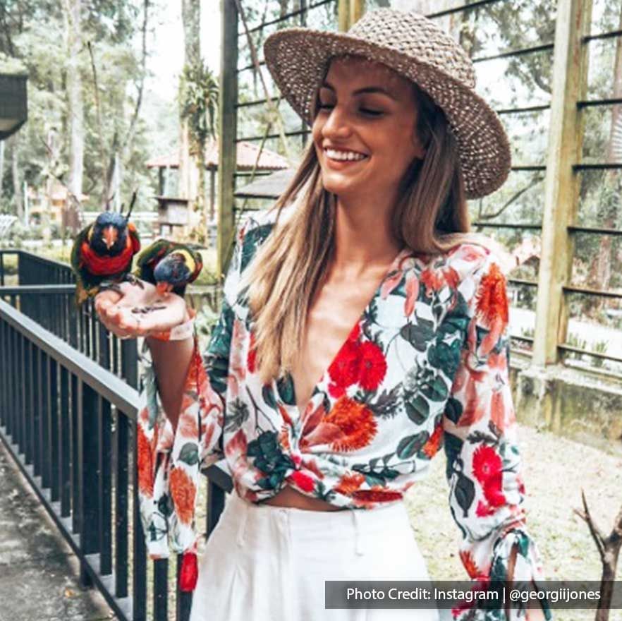 Lady holding two birds in KL Bird Park, a well-known attraction near Imperial Lexis Kuala Lumpur