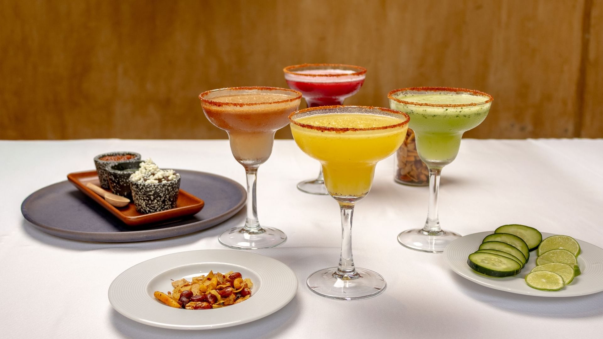 Four colorful frozen margaritas with salted rims served with spicy snacks at Quinta Real Oaxaca