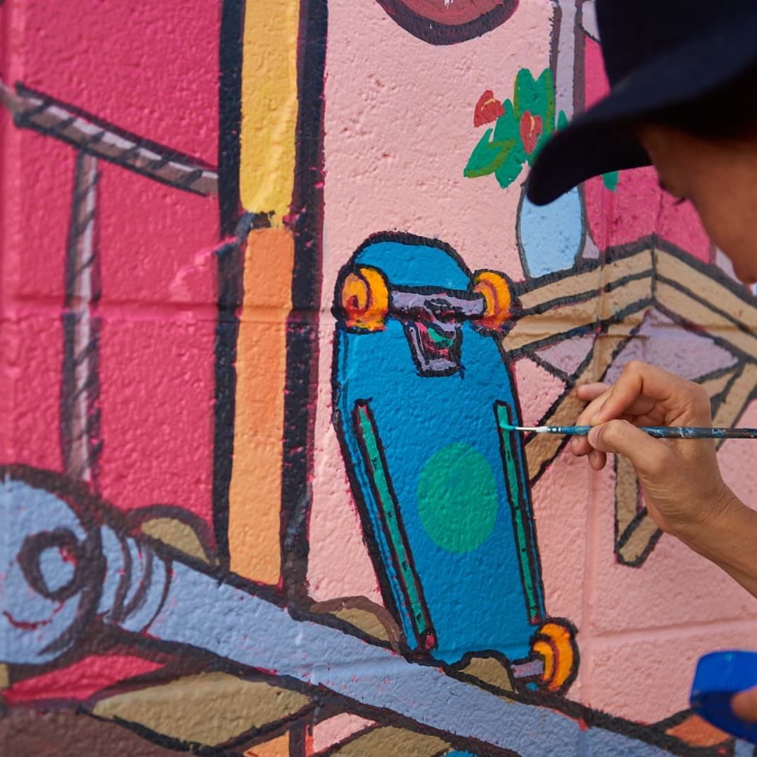 Close-up a person drawing wall art near Waikiki Resort Hotel by Sono