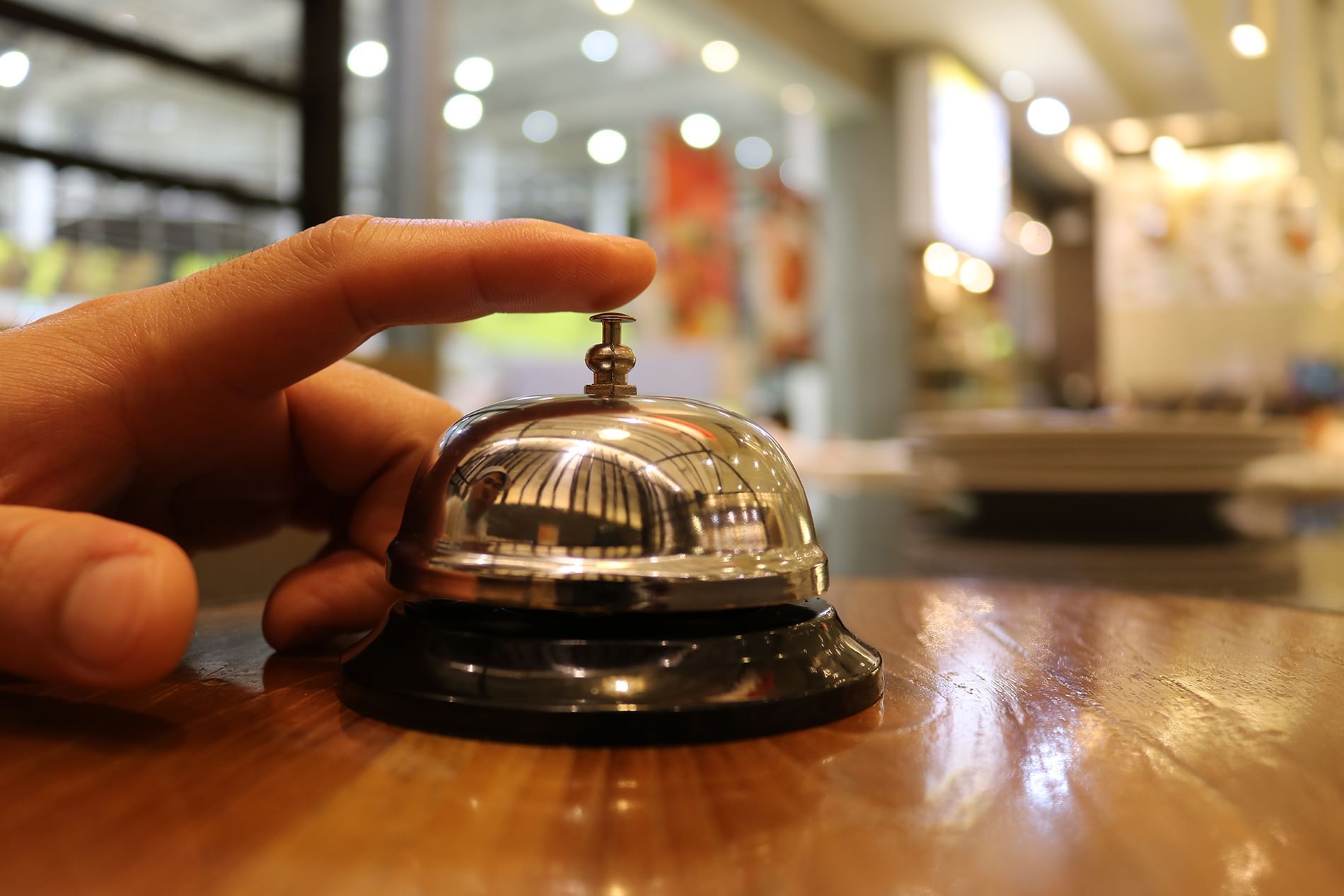Close-up of ringing the desk-bell at Mission Inn Riverside