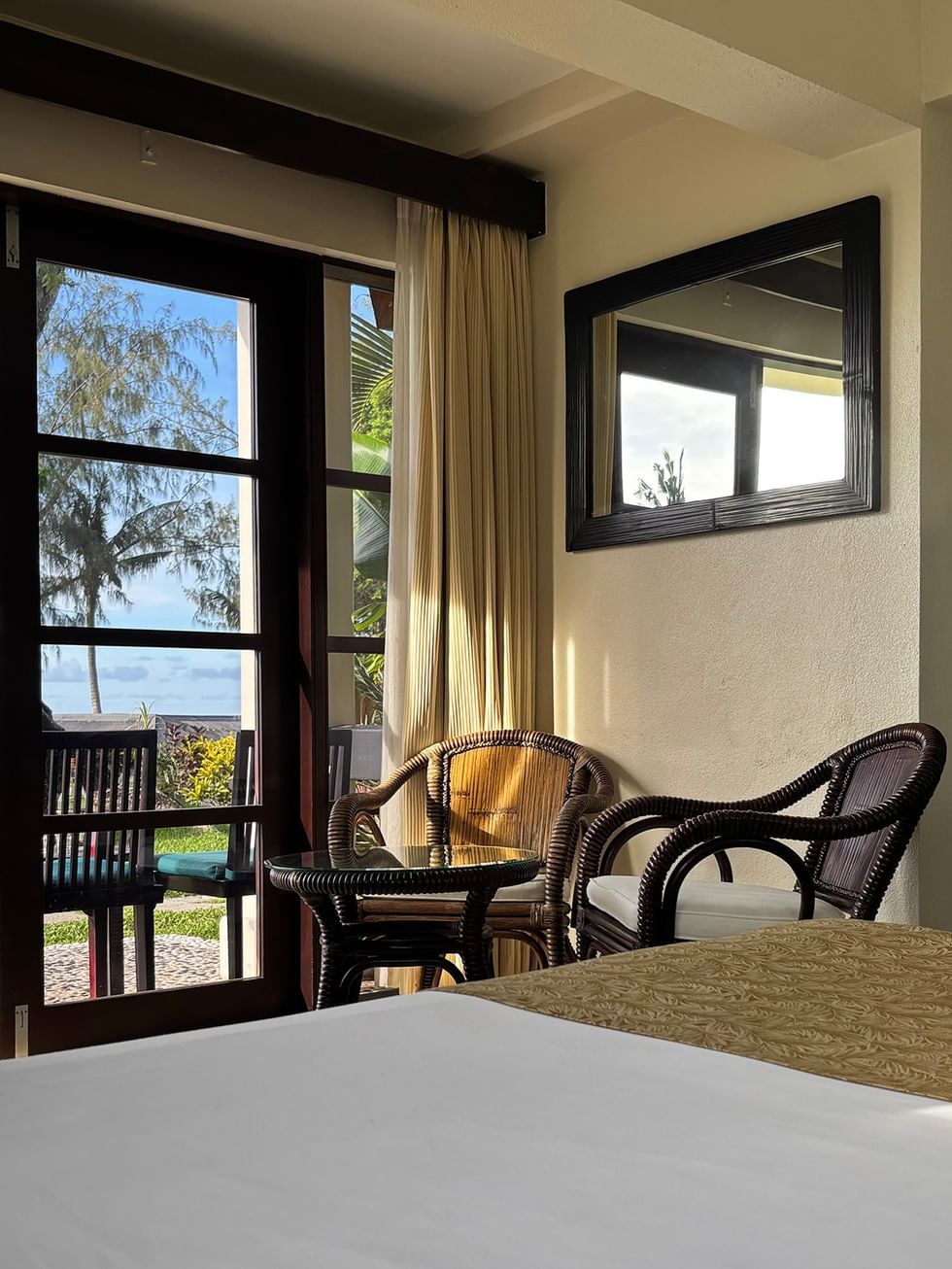 Lagoon View Room with balcony, chairs, and tropical scenery at Warwick Le Lagon - Vanuatu in Efate.