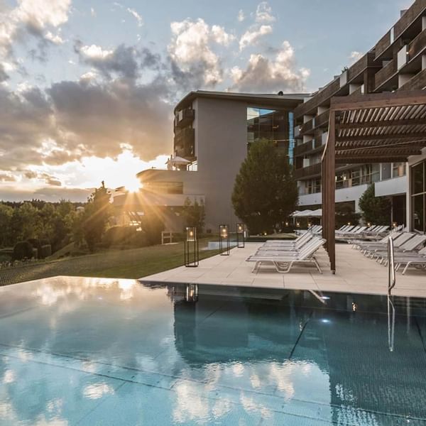 exterior view of the pool area by the garden at Falkensteiner Balance Resort Stegersbach