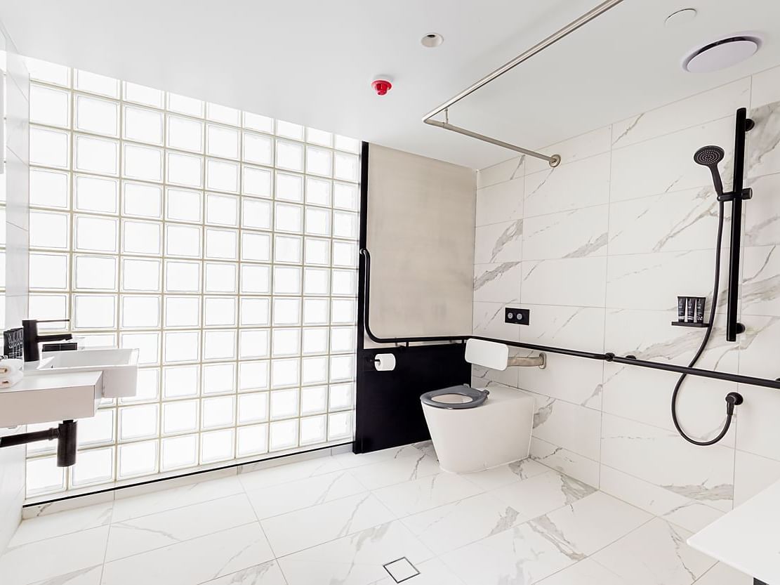 Shower area & vanity in the bathroom in a suite at Brady Hotels Jones Lane