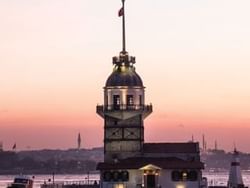 Exterior view of the Maiden's Tower with lights near CVK Hotels