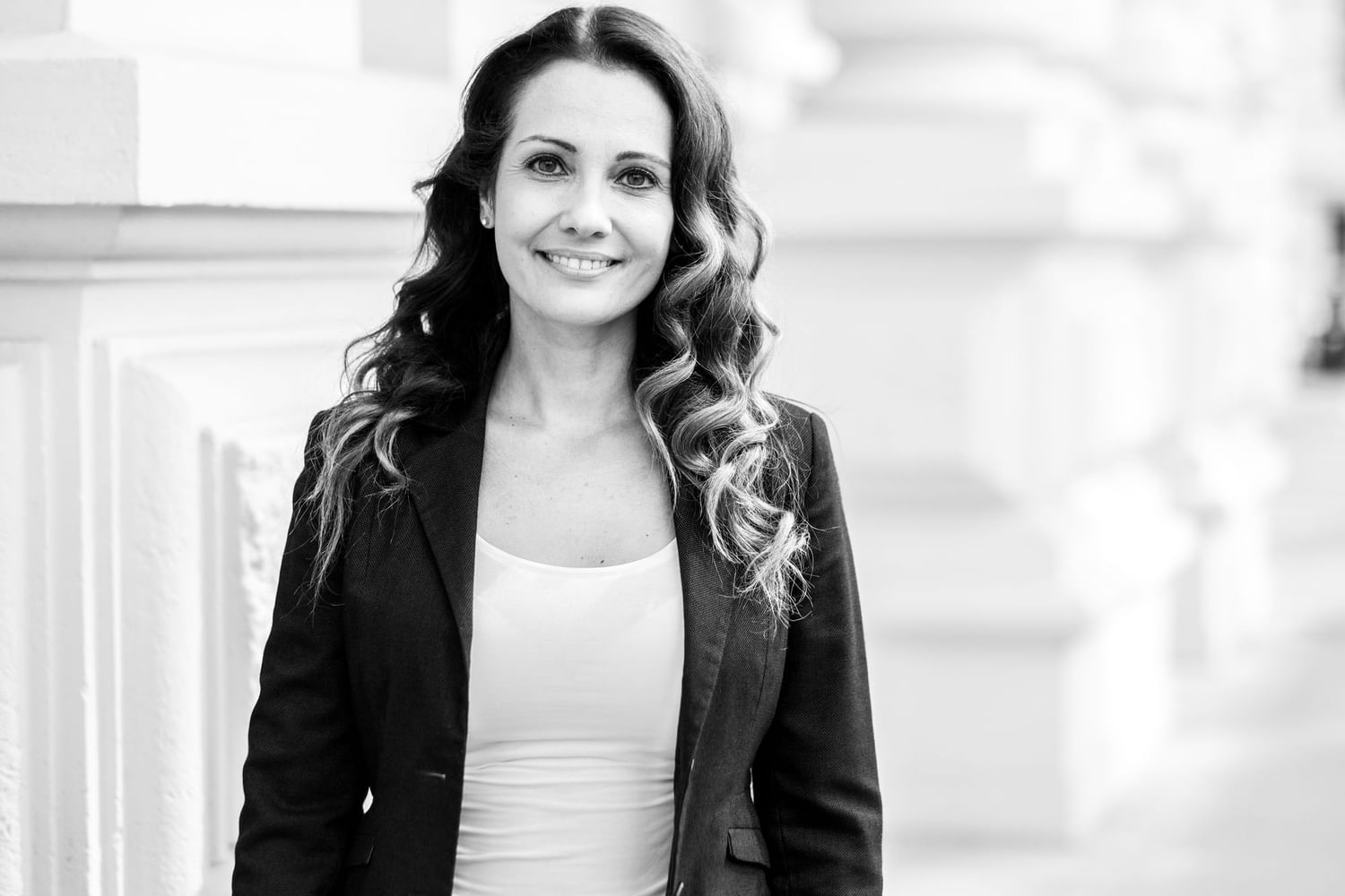 Curly-haired woman wearing a blazer at the Almanac Group